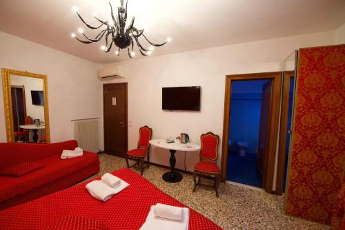 a hotel room with two beds and a television at Casa Dolce in Venice