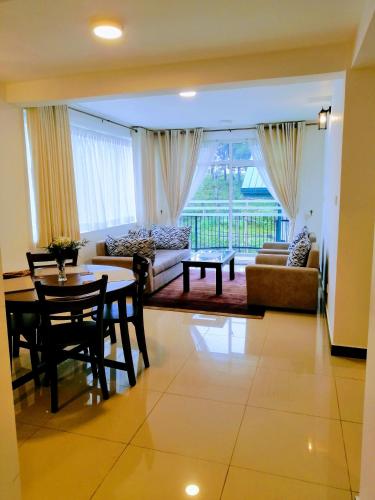 a living room with a table and a couch at Moon Plains Luxury Apartments in Nuwara Eliya