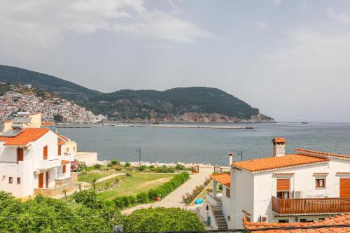 a view of the water and houses in a town at Fotis Studios in Skopelos Town