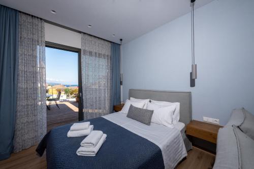 a bedroom with a bed with two towels on it at Melcon Luxury Suites in Parga