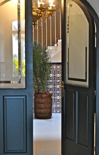 a blue door with a potted plant in a hallway at Hotel Rural La Raposera in Caravia