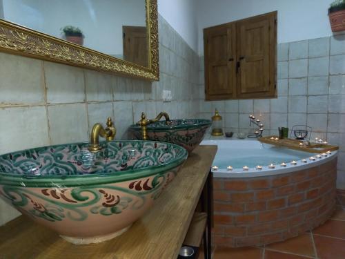 a bathroom with two sinks and a large tub at Cueva de Manuela in Guadix