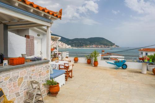 a balcony of a house with a view of the ocean at Fotis Studios in Skopelos Town