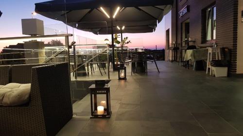 a rooftop patio with tables and umbrellas and candles at Calas De Liencres in Liencres