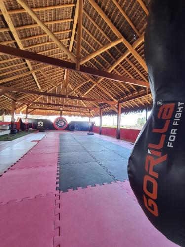 a large room with a pink carpeted floor in a building at Pousada Lua de Charme in Canoa Quebrada
