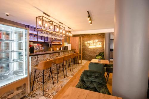 a restaurant with a bar with stools at OASIS Apartments in Gevgelija