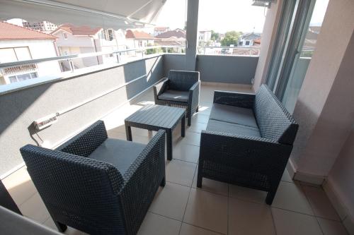 a balcony with chairs and tables on a building at OASIS Apartments in Gevgelija