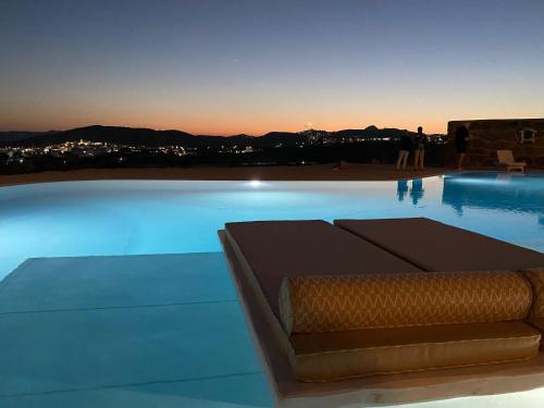 a view of a swimming pool at dusk at Blu Suites and Studios in Adamas
