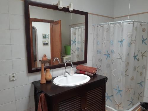 W łazience znajduje się umywalka i lustro. w obiekcie La Laja 13 w mieście Playa Blanca