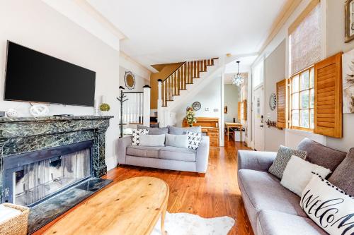 a living room with a fireplace and a tv at 4 Tully in Charleston