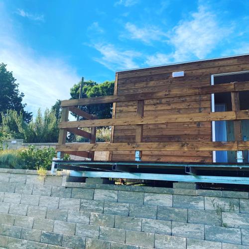 a wooden bench sitting in front of a building at Villa Silvio in Civitanova Alta