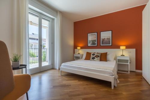 a bedroom with a bed and a large window at Guesthouse Libeticus in Cagliari