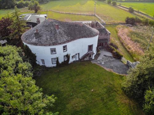 an aerial view of a large white house with a yard at Fiddleback Farm in Wigton