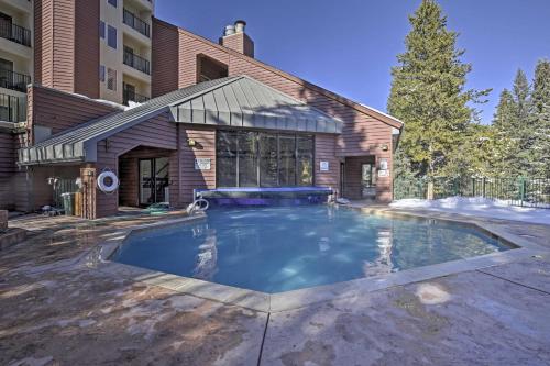 a swimming pool in front of a building at Cozy Ski-InandOut Winter Park Studio with Hot Tubs! in Winter Park