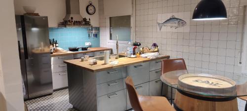 a kitchen with a table and a refrigerator at Villa Mas Sopes in Sant Pere Pescador
