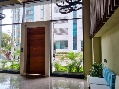 a door in a building with a large window at Apartasuites VITA 945 RODADERO - By Bedviajes in Santa Marta