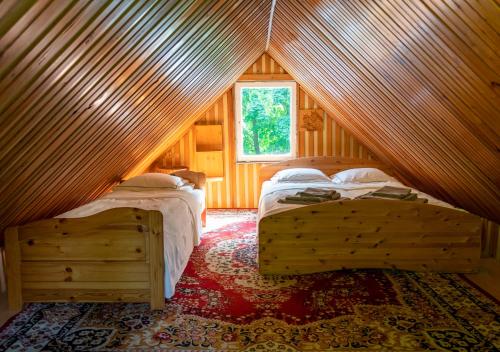 a bedroom with two beds in a attic at Domek Jaromierz in Czarne Górne