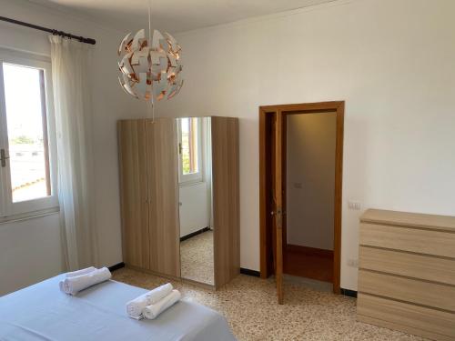 a bedroom with a bed with a mirror and a chandelier at KB House in Pula