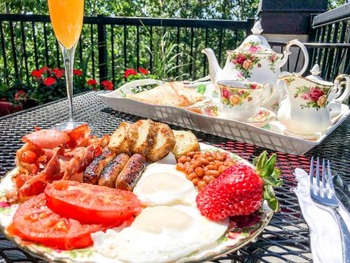 a plate of breakfast food on a table at Wolf Creek Bed and Breakfast in Ponoka