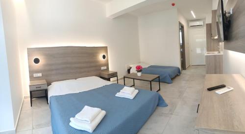 a hotel room with two beds with towels on them at Papatsas Center Houses in Nydri