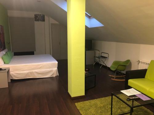 a room with a bed and a couch and a table at Calas De Liencres in Liencres