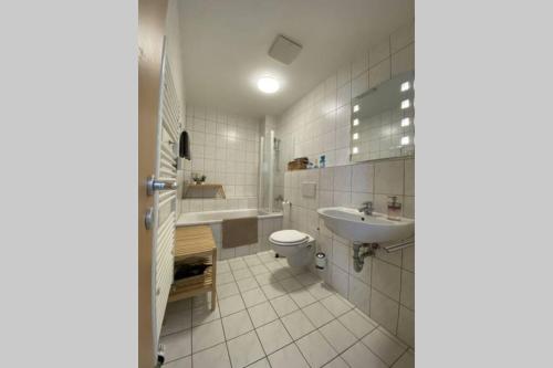 a bathroom with a toilet and a sink and a tub at Gemütliche Ferienwohnung in zentraler Lage in Erfurt