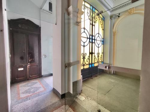 an empty hallway with a door and a window at Cernaia 25 in Turin