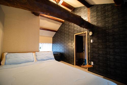 a bedroom with a large bed in a room at Kominka Wagaya in Higashi-osaka