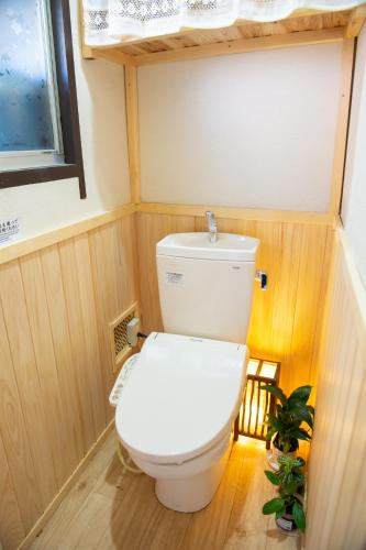 a bathroom with a toilet in a small room at Kominka Wagaya in Higashi-osaka
