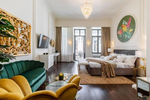 a living room with a bed and a couch at HOLT Old Town Suites with Balcony in Bucharest