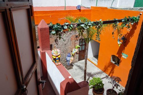 an overhead view of an orange building with plants at HOTEL BACANTES in Puebla