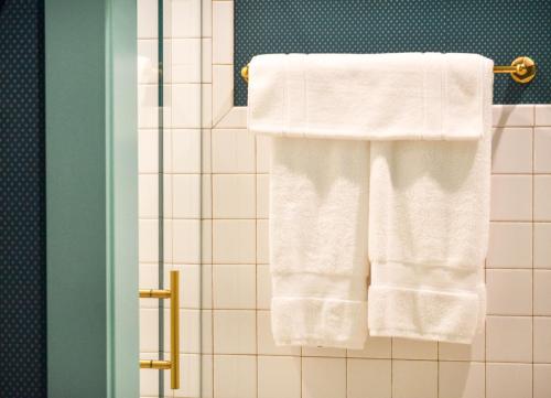 a bathroom with white towels hanging on a rack at Bradford House, a Member of Design Hotels in Oklahoma City