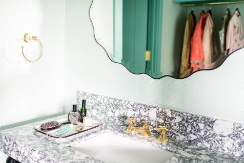 a bathroom with a sink and a mirror at Bradford House, a Member of Design Hotels in Oklahoma City
