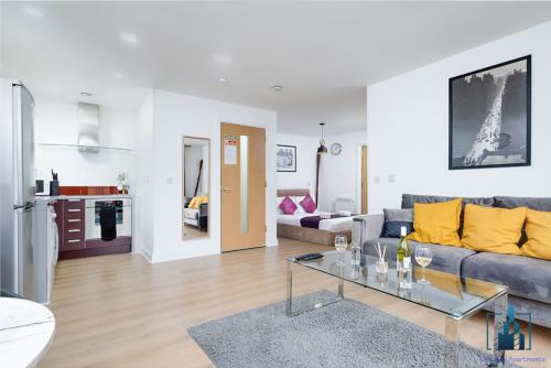 a living room with a couch and a table at City View Apartments Birmingham City Centre in Birmingham
