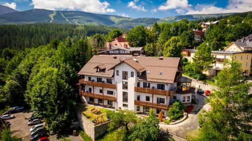 an aerial view of a large house in a village at Karpacki & SPA - blisko wyciągu, Restauracja, Sala Zabaw, Bar 24h in Karpacz