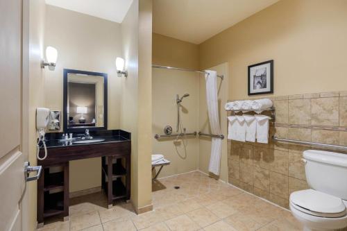 a bathroom with a toilet and a sink at Comfort Suites Near City of Industry - Los Angeles in La Puente