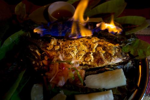 a plate of food with fire on top of it at Suchipakari Amazon Eco -Lodge & Jungle Reserve in Puerto Misahuallí