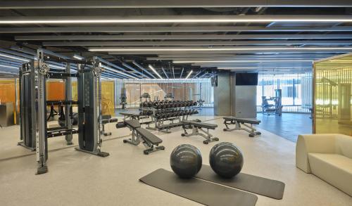 a gym with rows of exercise equipment in a room at WM Hotel Hong Kong, Vignette Collection in Hong Kong