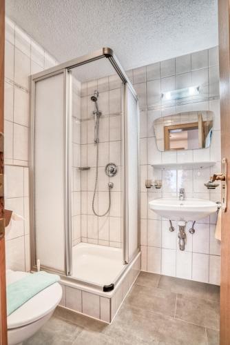 a bathroom with a shower and a toilet and a sink at Pension Weirather in Imst