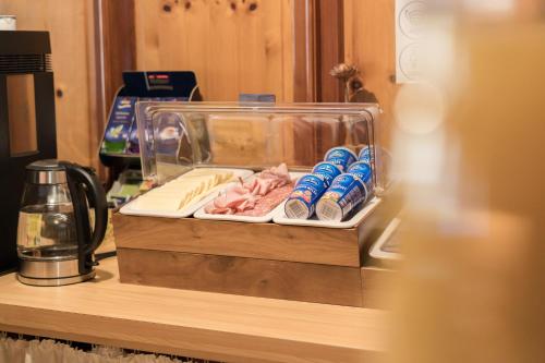 a clear container on a counter with drinks and food at Pension Weirather in Imst