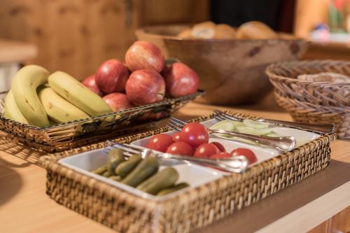 two baskets of fruits and vegetables on a table at Pension Weirather in Imst