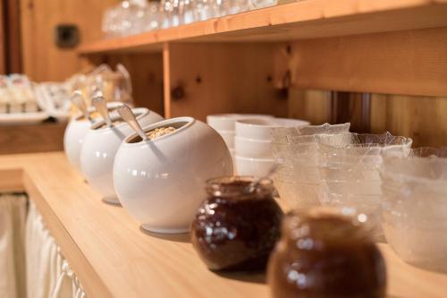 a counter with several bowls and glasses on it at Pension Weirather in Imst