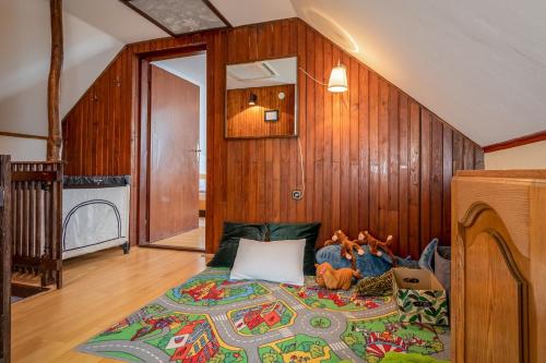 a bedroom with a large bed in a wooden wall at Farmstay Kotić in Slunj