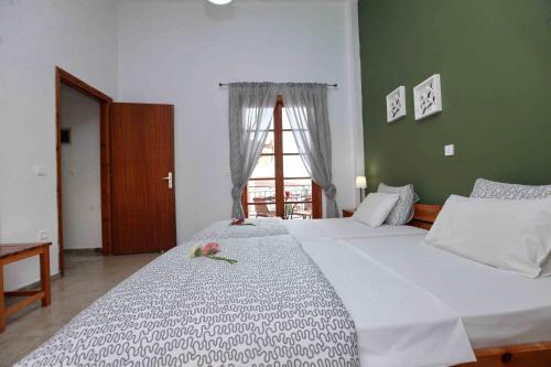 a large white bed in a room with a window at Sofia Apartments - Kantia in Kandia