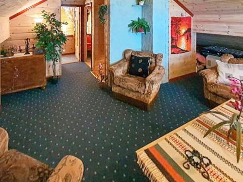a living room with couches and chairs in a room at 9 person holiday home in HUNDEIDVIK-By Traum in Hundeidvik