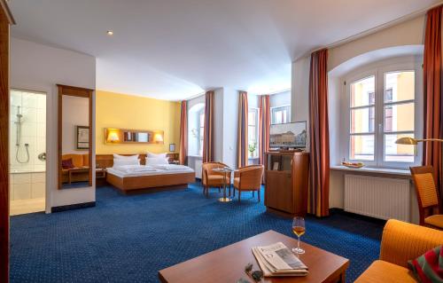 a hotel room with a bed and a table at Altstadthotel der Patrizier in Regensburg