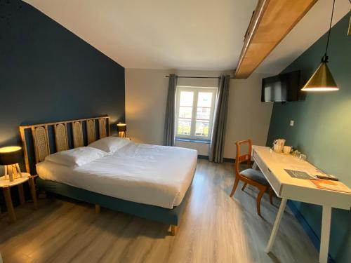 a bedroom with a bed and a desk and a table at Le Miredames Hôtel-Bar in Castres