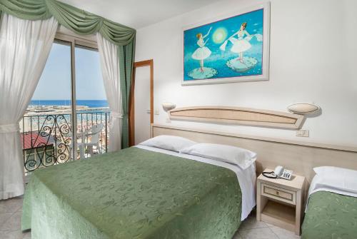 a hotel room with a bed and a balcony at Hotel Lido in Gabicce Mare