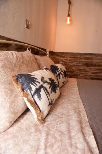 a bedroom with a bed with two pillows on it at Kampos Family Garden in Batsi