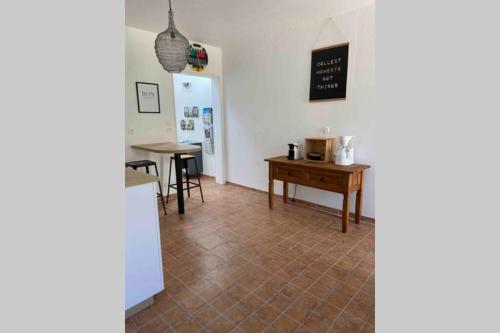 a living room with a table and chairs and a table at Chez Pat&Fred in Balnot-la-Grange